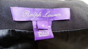 Ralph Lauren label on a black garment with a purple tag.