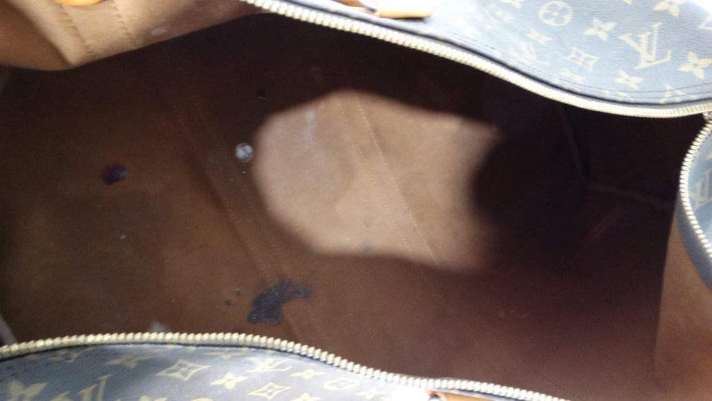 The Louis Vuitton Keepall 55 Monogram Coated Canvas Duffel Bag